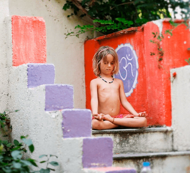 A younger child practices yoga